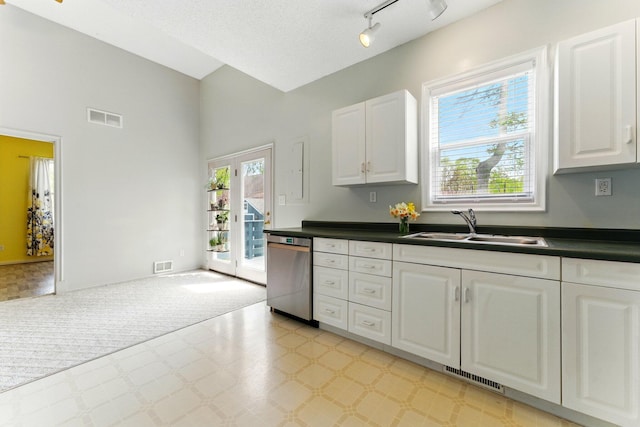 kitchen with light floors, visible vents, a sink, and dishwasher