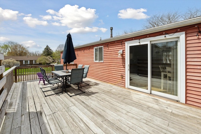 wooden terrace featuring outdoor dining space