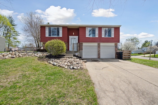 bi-level home featuring a garage, concrete driveway, a front yard, and brick siding