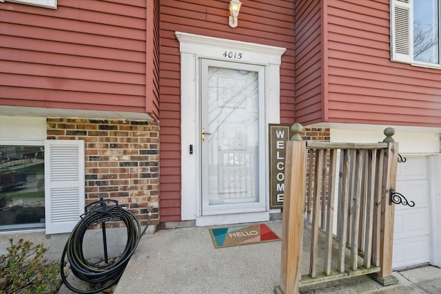view of exterior entry featuring brick siding