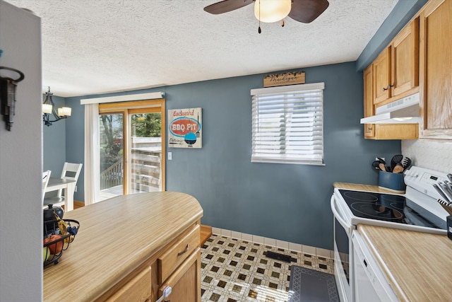 kitchen featuring white electric range, light countertops, baseboards, ceiling fan with notable chandelier, and under cabinet range hood