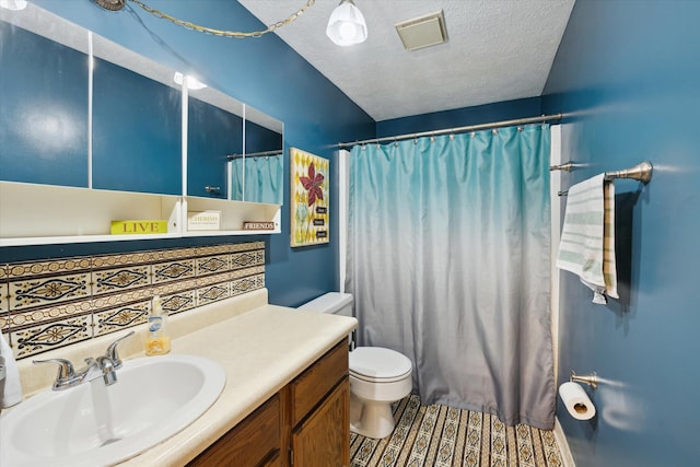 bathroom featuring visible vents, vanity, toilet, a shower with shower curtain, and a textured ceiling