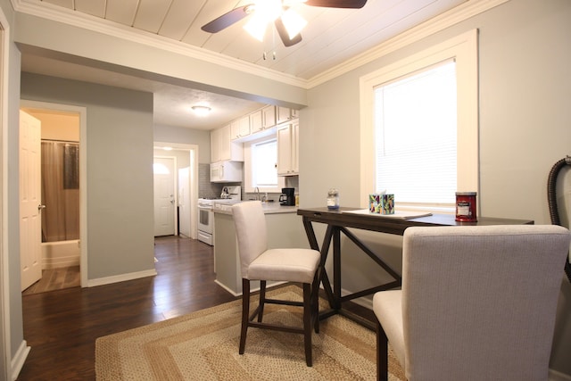 dining space with crown molding, a ceiling fan, baseboards, and dark wood-style floors