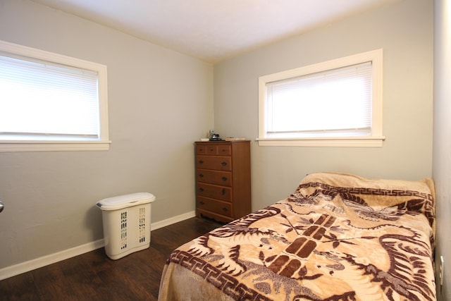 bedroom featuring baseboards and dark wood finished floors