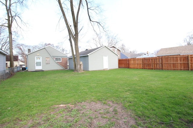 view of yard featuring a fenced backyard and an outbuilding