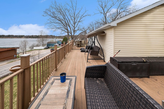 deck featuring central AC unit and a water view