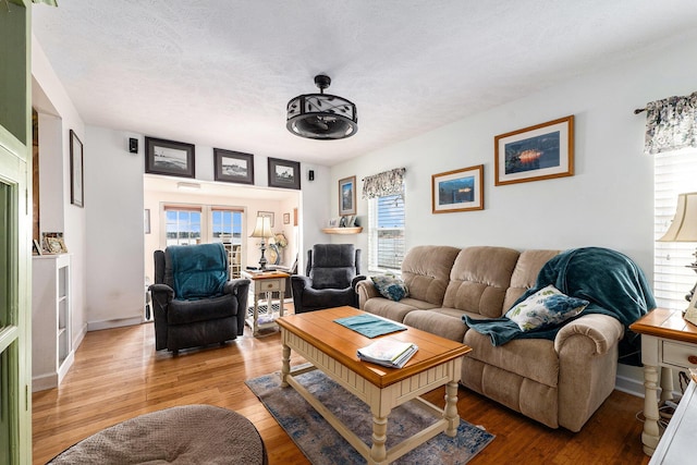living room featuring a textured ceiling and wood finished floors