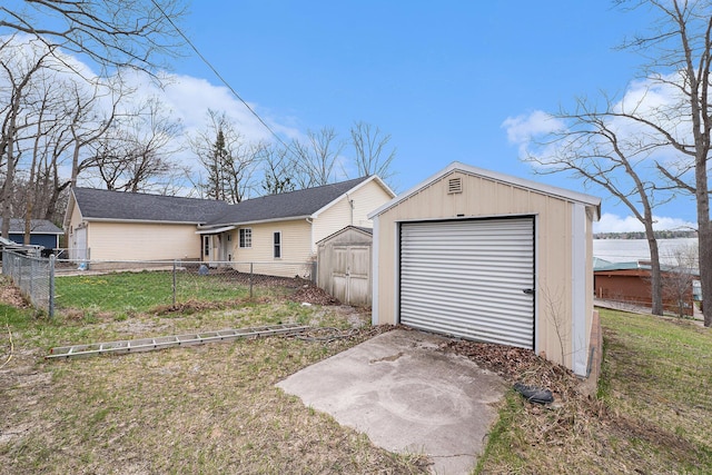 view of front of home with fence, an outdoor structure, a front lawn, and a storage shed