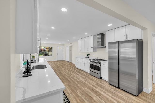 37451 Carpathia Blvd, Sterling Heights, MI 48310 - kitchen with wall chimney range hood, light wood-style floors, stainless steel appliances, and a sink