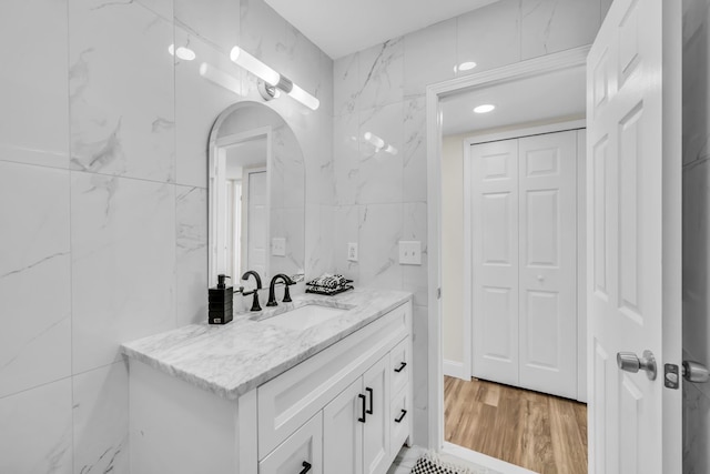 37451 Carpathia Blvd, Sterling Heights, MI 48310 - bathroom featuring vanity, wood finished floors, and tile walls
