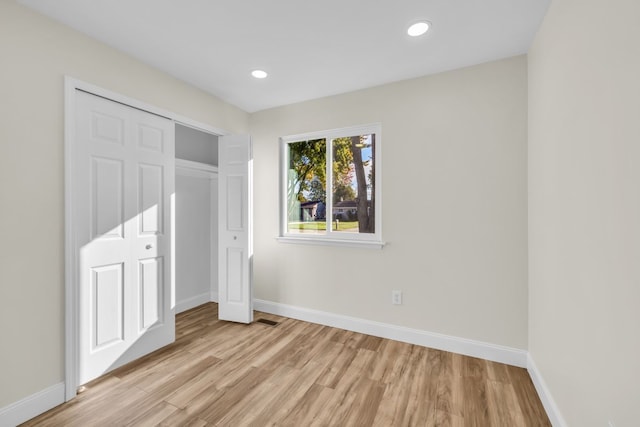 37451 Carpathia Blvd, Sterling Heights, MI 48310 - unfurnished bedroom with baseboards, light wood-style flooring, and a closet
