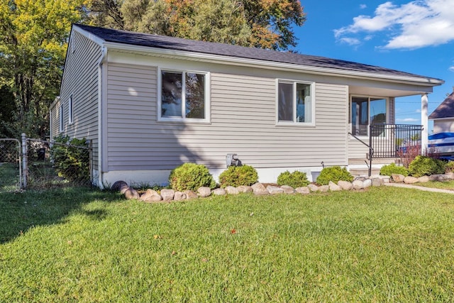 37451 Carpathia Blvd, Sterling Heights, MI 48310 - view of front of house featuring fence, roof with shingles, and a front lawn