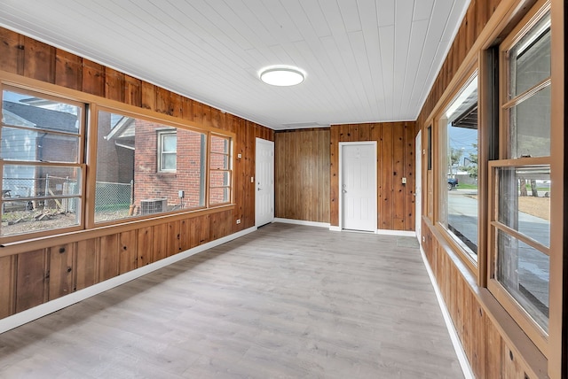 unfurnished sunroom with a wealth of natural light