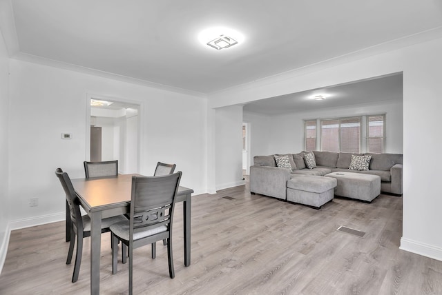 dining space featuring visible vents, baseboards, and light wood-type flooring