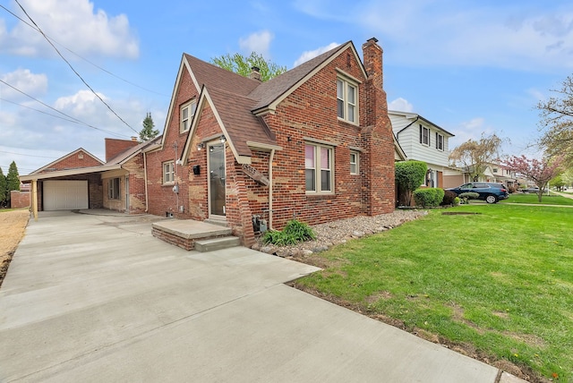 view of front of property featuring brick siding, a garage, driveway, and a front lawn
