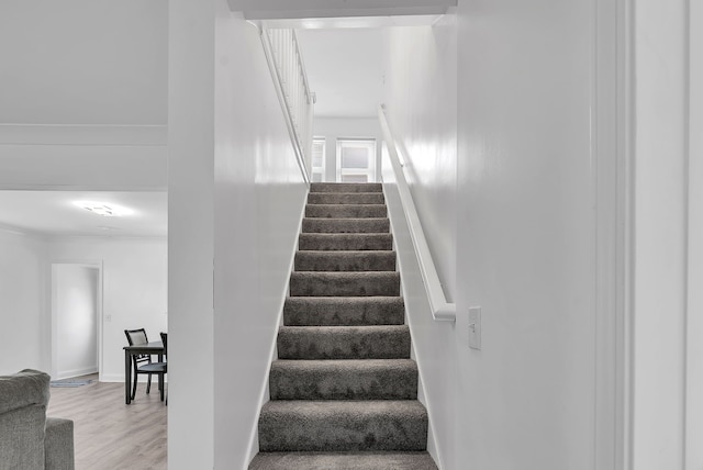 stairs featuring baseboards and wood finished floors