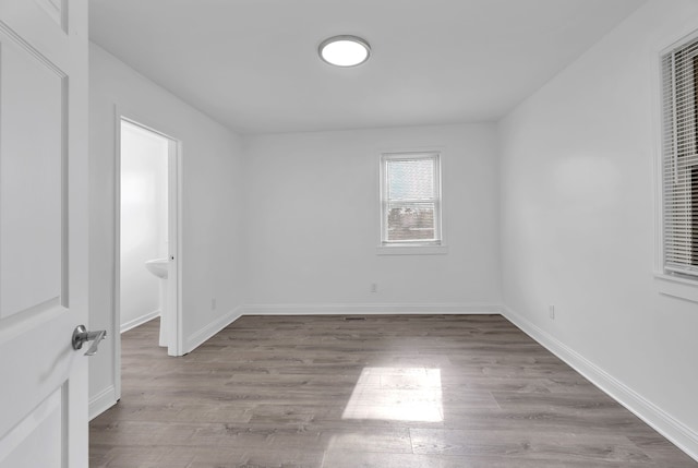 unfurnished bedroom featuring baseboards and wood finished floors