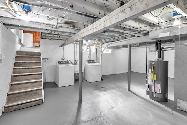 below grade area with water heater, washing machine and dryer, and stairway