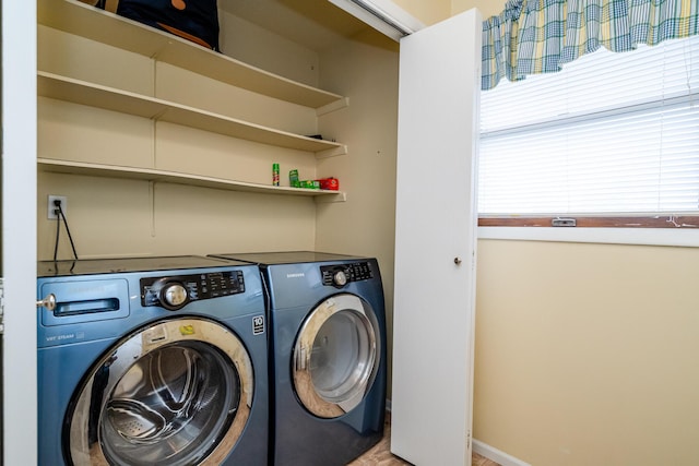 washroom featuring baseboards, laundry area, and washer and clothes dryer