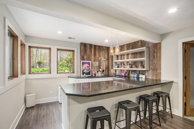 bar featuring dark wood-style flooring, baseboards, and recessed lighting