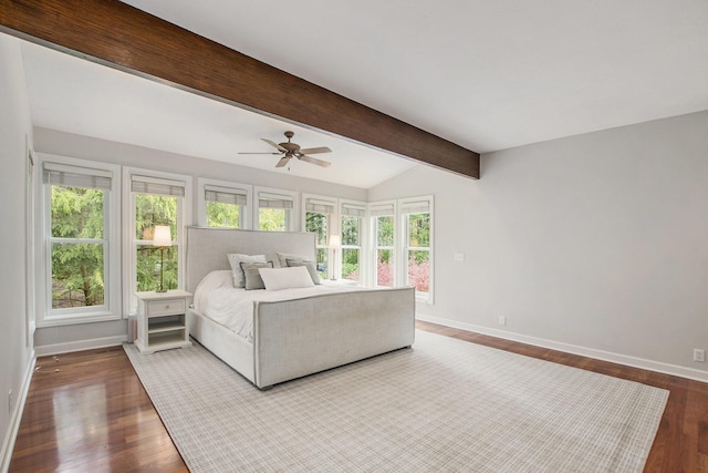 bedroom with a ceiling fan, baseboards, lofted ceiling with beams, and wood finished floors