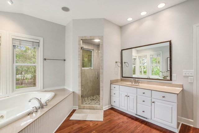 full bathroom with vanity, recessed lighting, wood finished floors, a garden tub, and a stall shower