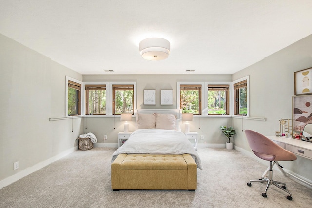 carpeted bedroom with baseboards and multiple windows