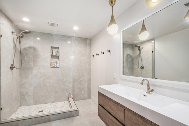 full bathroom featuring recessed lighting, visible vents, a tile shower, and vanity
