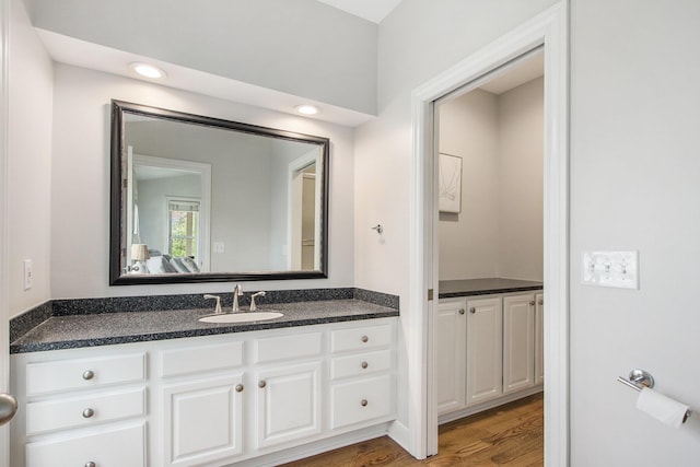 bathroom with wood finished floors and vanity
