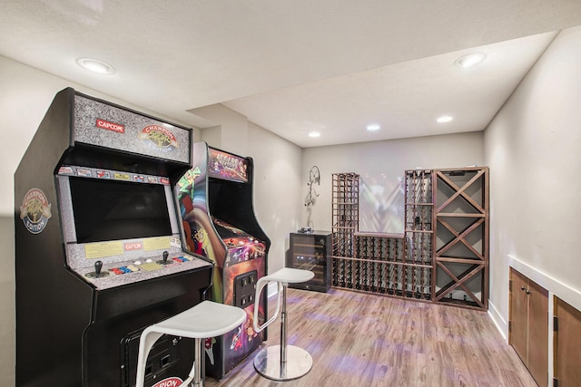 recreation room featuring baseboards, recessed lighting, and wood finished floors