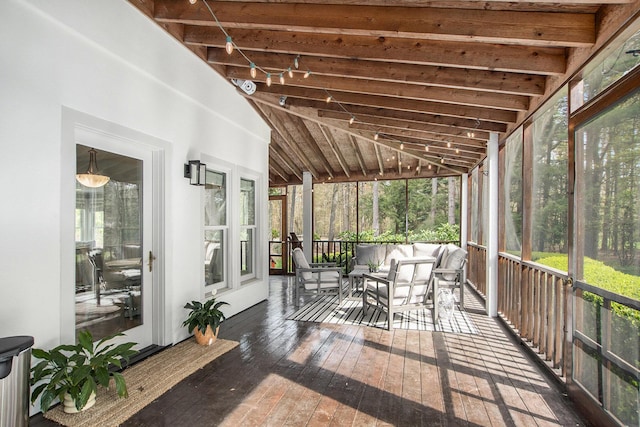 sunroom with a healthy amount of sunlight and an outdoor living space