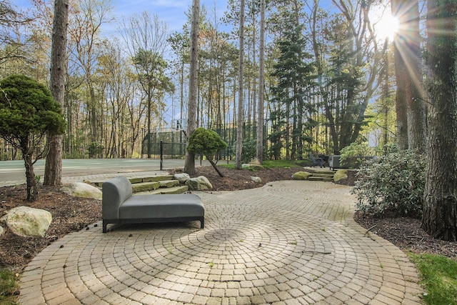 view of home's community with fence and a patio area