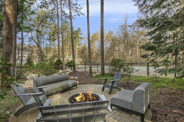 view of patio / terrace with fence and an outdoor fire pit