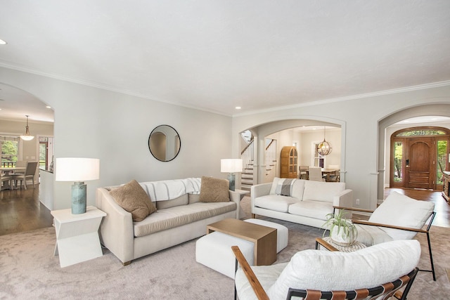 living room with crown molding, arched walkways, wood finished floors, and recessed lighting