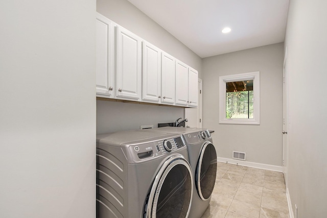 washroom with visible vents, washing machine and dryer, cabinet space, baseboards, and recessed lighting