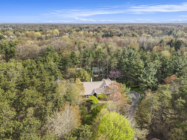 drone / aerial view with a wooded view