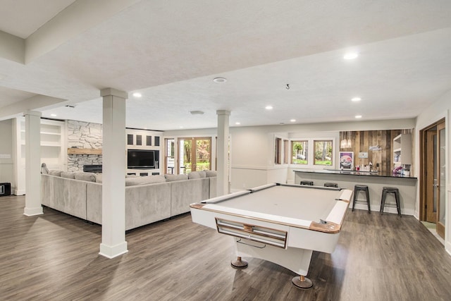 recreation room featuring ornate columns, recessed lighting, and dark wood-style floors