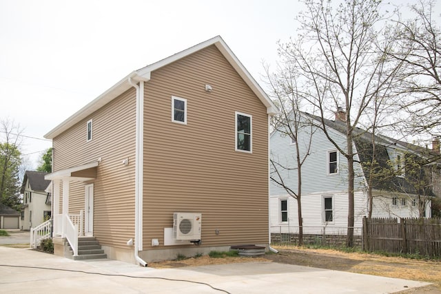 view of property exterior featuring ac unit and fence