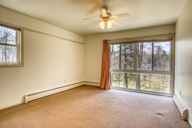 carpeted empty room with a baseboard radiator and a ceiling fan
