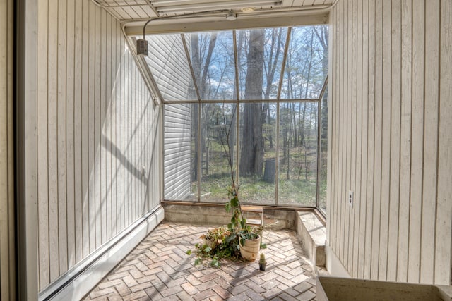 sunroom with a baseboard heating unit