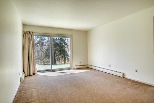 spare room with baseboard heating, baseboards, a baseboard radiator, and carpet