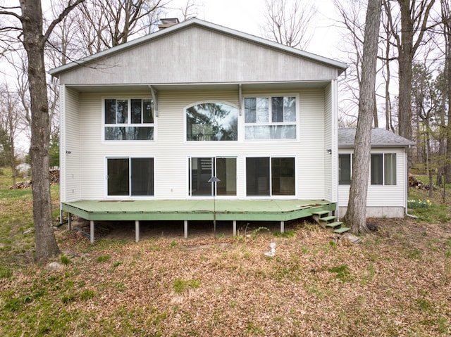 back of house featuring a wooden deck