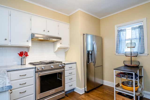 kitchen with dark wood-style flooring, appliances with stainless steel finishes, baseboards, decorative backsplash, and under cabinet range hood