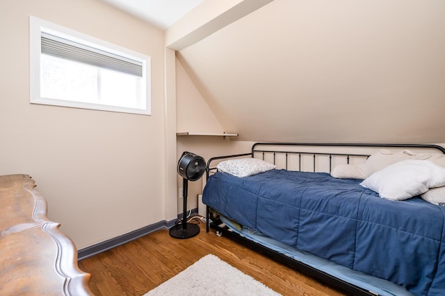 bedroom featuring baseboards and wood finished floors