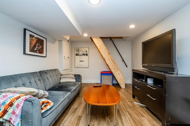 living room featuring recessed lighting, baseboards, and light wood-style flooring
