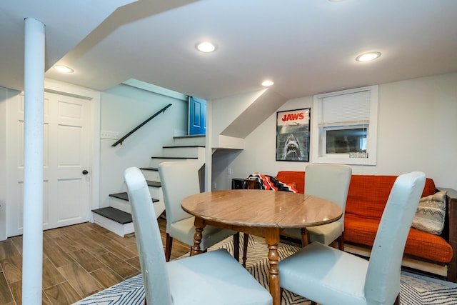 dining space featuring recessed lighting, stairs, and wood finished floors