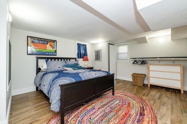 bedroom with baseboards and wood finished floors