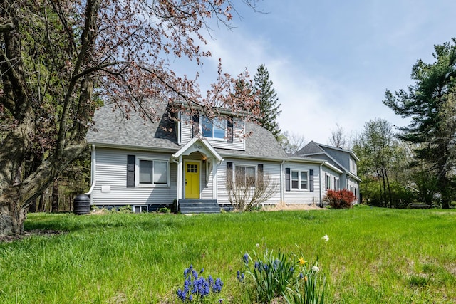 bungalow featuring central air condition unit and a shingled roof
