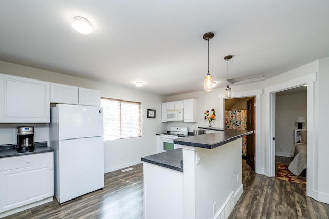 kitchen featuring visible vents, dark countertops, dark wood finished floors, white cabinets, and white appliances