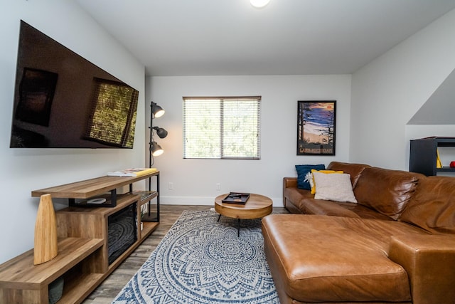 living room featuring baseboards and wood finished floors